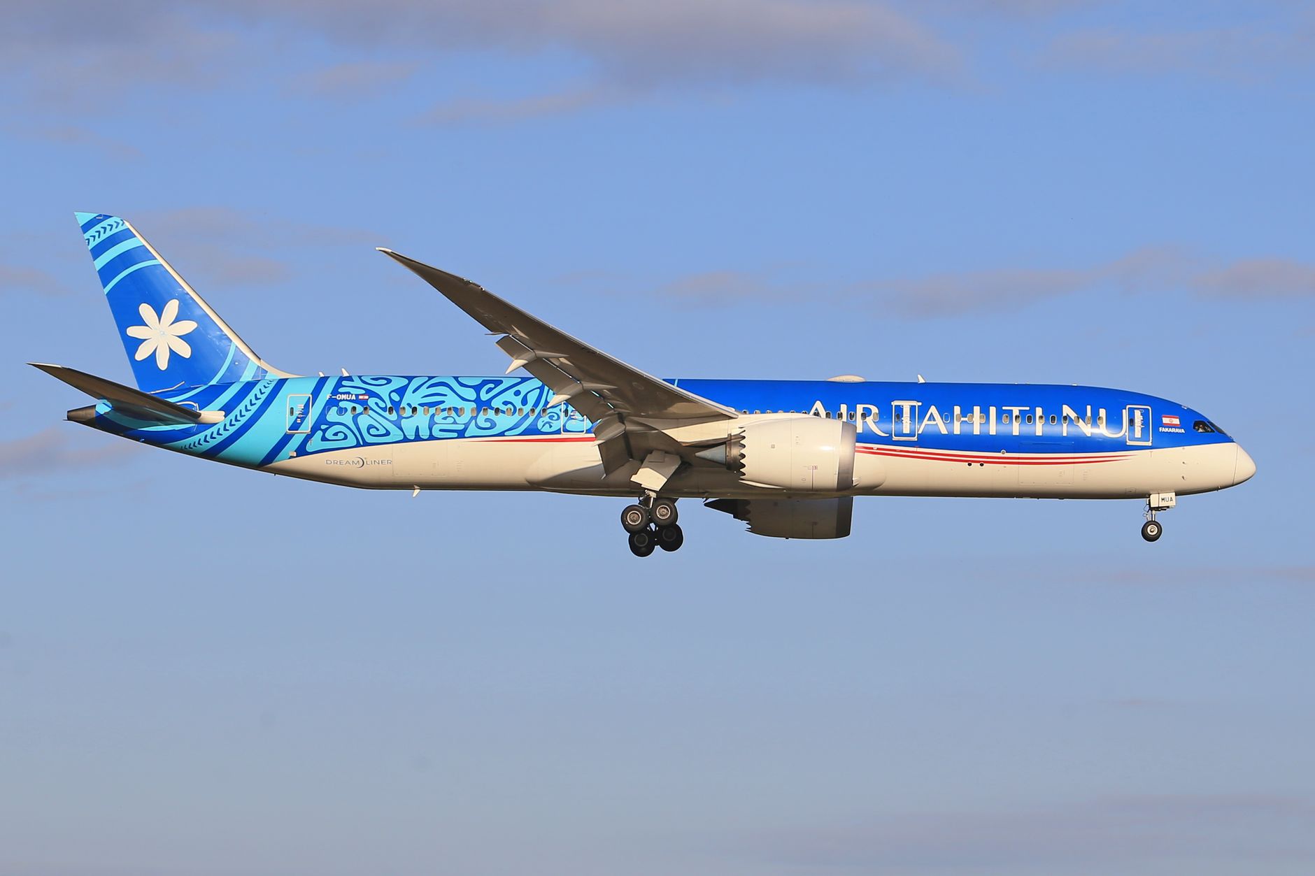Stunning image of Air Tahiti Nui Boeing 787 Dreamliner soaring in a clear blue sky.